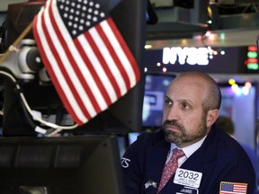 Specialist James Denaro works at his post on the floor of the New York Stock Exchange, Monday, Dec. 4, 2017. Stocks rose Monday on expectations that lower taxes will help corporate profits pile up even higher.