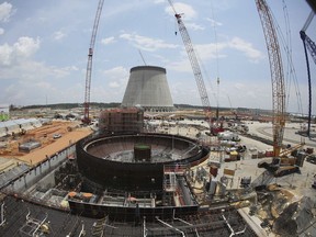 FILE- This June 13, 2014, file photo, shows construction on a new nuclear reactor at Plant Vogtle power plant in Waynesboro, Ga. In a Thursday, Dec. 21, 2-17 decision, Georgia's utility regulators are allowing construction to continue on two new nuclear reactors at Plant Vogtle despite massive cost overruns for the multi-billion-dollar project.