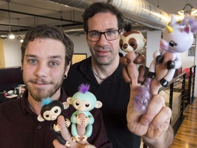 Wowee creative director Benny Dongarra, right, and mechanical engineer Anthony Lemire hold Fingerlings Thursday, December 7, 2017 in Montreal.