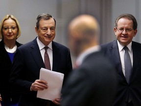 President of the European Central Bank Mario Draghi , 2nd left, and vice president Vitor Constancio, right, go to a news conference in Frankfurt, Germany, Thursday, Dec. 14, 2017.