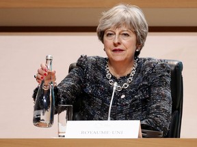 British Prime Minister Theresa May attends the plenary session of One Planet Summit, in Boulogne-Billancourt near Paris, France, Tuesday, Dec. 12, 2017. World leaders, investment funds and energy magnates promised to devote new money and technology to slow global warming at a summit in Paris that President Emmanuel Macron hopes will rev up the Paris climate accord that U.S. President Donald Trump has rejected.