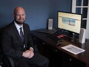 In this Dec. 20, 2017 photo, Justin Dopierala sits in his home office of DOMO Capital Management, LLC in Germantown, Wisc. Anticipating the passage of the Republican tax plan, he said he spent $20,000 on business improvements over the last couple months, including a new website and marketing pitch book for potential clients, included in this photo. Dopierala expects to have a nearly $11,000 reduction in taxes on his $150,000 income. He said he generally votes for Republicans and voted for Trump, partly expecting he would pass a new tax plan.