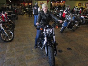 In this Dec. 12, 2017, photo, Samantha Kay poses for a photo on a 2017 Harley Sportster Forty-Eight in Milwaukee's House of Harley. Kay took a riding course at the dealership as part of Harley-Davidson's "Riding Academy," an initiative the company hopes will help bring new customers.