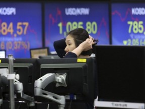 A currency trader watches monitors at the foreign exchange dealing room of the KEB Hana Bank headquarters in Seoul, South Korea, Monday, Dec. 4, 2017. Asian stock markets were mostly higher on Monday, with U.S. politics in focus.