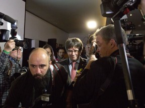 Ousted Catalan leader Carles Puigdemont, center, leaves after a press conference at the Square Meeting Center in Brussels on Thursday, Dec. 21, 2017. The pro-secession bloc won a majority in Catalan regional elections, but the anti-independence Ciutadans (Citizens), led by 36-year-old lawyer Ines Arrimadas, won the highest number of votes for a single party. Several members of the ousted Cabinet, including Puigdemont, have campaigned from Brussels, where they sought refuge from Spanish justice.