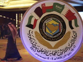The seal of the Gulf Cooperation Council and an announcement of its meeting this week is on display in Kuwait City, Monday, Dec. 4, 2017. Qatar's ruling emir will attend the meeting of the Gulf Cooperation Council this week in Kuwait, his government said Monday, a summit coming amid a boycott of the energy-rich country by three of the council's members.