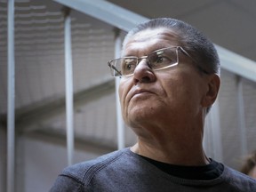 Former Russian Economic Development Minister Alexei Ulyukayev waits for his hearing at a court in Moscow, Russia, Friday, Dec. 15, 2017. A Moscow court is expected to deliver a verdict in the case of former Economic Development Minister Alexei Ulyukayev who is on trial for accepting a $2 million bribe from a close ally of President Vladimir Putin.