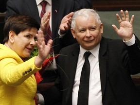 Jaroslaw Kaczynski, the powerful leader of Poland's ruling Law and Justice party and Prime Minister Beata Szydlo wave after her government survived a vote in which the opposition was seeking to oust it, at the parliament buildingin Warsaw, Poland, Thursday, Dec. 7, 2017.