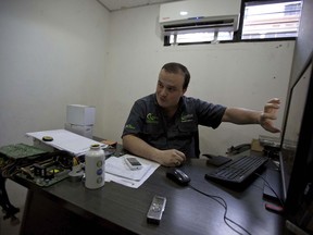 John Villar speaks during an interview at his office in Caracas, Venezuela, Tuesday, Dec. 12, 2017. In the last month, John Villar has bought two plane tickets to Colombia, purchased his wife's medication and paid the employees of his startup business in Venezuela - all in bitcoin.