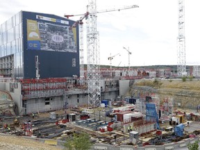 FILE - In this Sept. 15, 2016 file photo, cranes stand at the construction site of the ITER ( the International Thermonuclear Experimental Reactor) in Cadarache, southern France. A vast international experiment designed to demonstrate that nuclear fusion can be a viable source of clean and cheap energy is halfway toward completion. The organization behind the ITER announced the milestone Wednesday Dec. 6, 2017 and confirmed it's aiming to conduct a first test run in 2025.