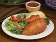 Swiss Chalet is abandoning its familiar plating style, shown, and adding new salads and side dishes in an effort to modernize the restaurant and draw in more diners.