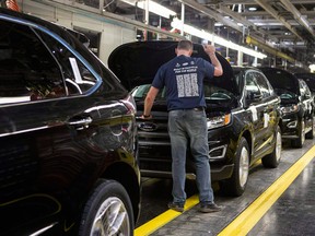 New Ford Edges sit on a production line as Ford Motor Company celebrates the global production start of the 2015 Ford Edge at the Ford Assembly Plant in Oakville, Ont.