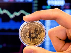 An Israeli holds a visual representation of the digital cryptocurrency Bitcoin, at the "Bitcoin Change" shop in the Israeli city of Tel Aviv on January 17, 2018. At the end of 2017 Israel Securities Authority said it was moving to ban trading in cryptocurrency-based companies on the Tel Aviv market until transactions involving digital coins are legally regulated. / AFP PHOTO / JACK GUEZJACK GUEZ/AFP/Getty Images