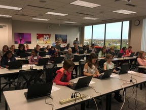 A classroom of girls learn to design video games at a recent Girls Make Games event in Ann Arbor, Michigan.