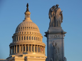 The last rays of sunlight fall on the dome of the U.S. Capitol in Washington.