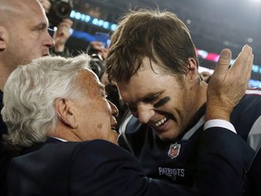 New England Patriots owner Robert Kraft, left, embraces quarterback Tom Brady after defeating the Jacksonville Jaguars in the AFC championship NFL football game, Sunday, Jan. 21, 2018, in Foxborough, Mass. The Patriots won 24-20.