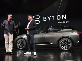 The president of Byton Daniel Kirchert, left, and CEO Carsten Breitfeld speak during the launch of the Byton connected car during CES 2018 in Las Vegas.