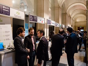 Attendees talk beside fintech company exhibition stands, at the Paris Fintech Forum this week. The show features about 2,000 international attendees and more than 200 speakers.