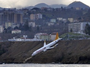 A Boeing 737-800 of Turkey's Pegasus Airlines after skidding off the runway downhill towards the sea at the airport in Trabzon, Turkey, Sunday, Jan. 14, 2018. Trabzon Gov. Yucel Yavuz said all 162 passengers and crew on board were evacuated and safe early Sunday. The cause of the accident was not yet known. (DHA-Depo Photos via AP)