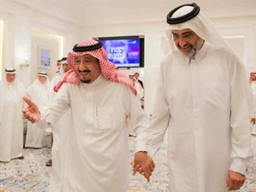 FILE- In this Aug. 17, 2017 file photo, released by the state-run Saudi Press Agency, Saudi King Salman, left, walks with Qatari Sheikh Abdullah bin Ali Al Thani, right, at the monarch's vacation home in Tangiers, Morocco. Exiled Sheikh Abdullah, once promoted by Saudi Arabia amid its ongoing dispute with Doha, appeared in an online video posted Sunday, Jan. 14, 2018, and aired by Doha-based satellite news network Al-Jazeera, claiming he's being held against his will in the United Arab Emirates, an allegation denied by an Abu Dhabi official. (Saudi Press Agency via AP)