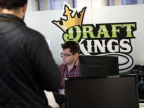 In this Thursday, Jan. 11, 2018 photo, employees work at the DraftKings office in Boston. The leading daily fantasy sports company has launched a new sports game that lets users hone in on a single NFL football playoff game, which has some gambling experts wondering if the contest inches the industry closer to the territory of sports betting that remains illegal in most of the United States.