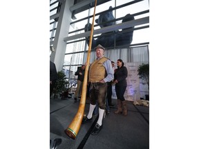 Helmut Fricker, of Vail, Colo., holds his alphorn after playing it at the opening of the Outdoor Retailers and Snow Show in the Colorado Convention Center, Thursday, Jan. 25, 2018, in Denver. Three floors of all the latest products for outdoor use makes the event the largest U.S. trade show for the outdoor and winter sports industries that represent $887 billion in sales.