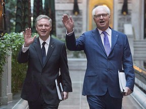 Power Corporation Chairman and Co-Chief Executive Officer Paul Desmarais, left, and Deputy Chairman, President and Co-CEO Andre Desmarais arrive for the company's annual general meeting in Montreal on May 13, 2016. Power Corp. of Canada says Andre Desmarais has resumed his full executive duties at the company.