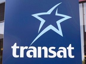 An Air Transat sign is seen Tuesday, May 31, 2016 in Montreal.An airline passenger rights advocate is suing the Canadian Transportation Agency and Air Transat over an incident last summer in which hundreds of people were left stranded in planes on the tarmac at Ottawa airport for hours.