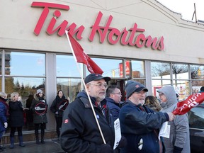 Members of Ontario Federation of Labour protest outside a Tim Hortons Franchise in Toronto on Wednesday January 10, 2018.