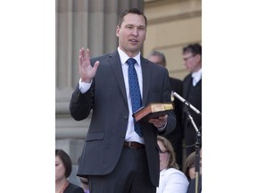 Deron Bilous is sworn in as the Alberta Minister of Municipal Affairs, Service Alberta in Edmonton on Sunday, May 24, 2015. The licence plate fight between Saskatchewan and Alberta is over. An Alberta government spokesman says Saskatchewan informed them by letter today it is rescinding its ban on vehicles with Alberta licence plates on Saskatchewan government project sites.