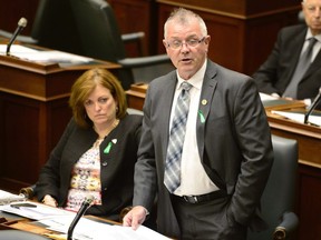 Ontario Labour Minister Kevin Flynn speaks at the legislature in Toronto, Monday, May 25, 2015. Ontario's minister of labour suggests businesses struggling with new legislation that hikes minimum wages should consider price increases. Kevin Flynn says that businesses have many options open to them, adding that raising prices could be part of a strategy to ensure they make a profit as well as pay a living wage.