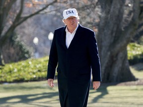 President Donald Trump walks across the South Lawn as he arrives at the White House in Washington, Sunday, Jan. 7, 2018, after traveling from Camp David, Md.