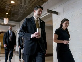 House Speaker Paul Ryan of Wis., center, accompanied by his Press Secretary AshLee Strong, right, walks to the Capitol Building from the Capitol Visitor's Center, Thursday, Jan. 18, 2018, in Washington.
