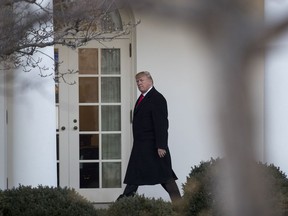 President Donald Trump walks along to colonnade to the Oval Office of the White House in Washington, Thursday, Jan. 18, 2018, as he returns from Pittsburgh.