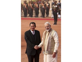 Indian Prime Minister Narendra Modi, right, shakes hands with Cambodian Prime Minister Hun Sen during the ceremonial reception at the Indian presidential palace in New Delhi, India, Satruday, Jan. 27, 2018.