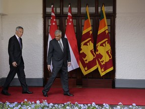 Sri Lanka's Prime Minister Ranil Wickremesinghe leads his Singaporean counter part Lee Hsien Loong as they walk for their talks in Colombo, Sri Lanka, Tuesday, Jan. 23, 2018.