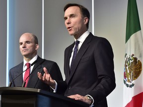 Finance Minister Bill Morneau (right) and his Mexican counterpart Jose Antonio Gonzalez Anaya hold a news conference in Toronto, Thursday, Jan.18, 2018, following their bilateral meeting and roundtable discussions with Canadian business leaders from the energy, mining and financial sectors who have investments and operations in Mexico.