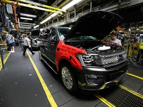 A worker inspects a 2018 Ford Expedition SUV at a plant in Louisville, Ken., on Oct. 27, 2017.