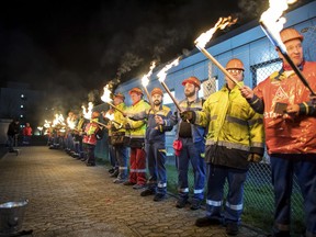 The night shift workers meet for a warning strike assembly of the IG Metall (Industrial Union of Metalworkers) in front of the gates of the Aluminium Norf GmbH in Neuss, Germany, Tuesday, Jan. 9, 2018. Germany's largest industrial union pressed its demands for pay rises and the possibility for reduced work hours for its 3.9 million members with renewed short-term strikes Tuesday, saying the economy's steady growth justifies better compensation and conditions.