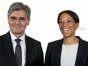 Siemens CEO Joe Kaeser, left, and Janina Kugel, board member in charge of HR, arrive for the annual press conference of the German industrial giant in Munich, southern Germany, Wednesday, Jan. 31, 2018.