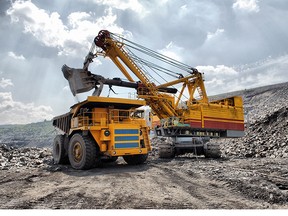 Loading of iron ore on very big dump-body truck HDR