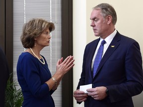 File - In this Jan. 22, 2018, file photo, Sen. Lisa Murkowski, R-Alaska, left, talks with Interior Secretary Ryan Zinke, right, before an event in her office on Capitol Hill in Washington. Alaska's pro-development congressional delegation is asking the Trump administration to back off from offering nearly all lands off the state's coast for petroleum leases. In a letter Friday, Jan. 26, 2018, to Zinke, Alaska Senators Murkowski and Dan Sullivan and Rep. Don Young say Cook Inlet, where petroleum extraction now occurs, and Arctic waters should be offered in lease sale plans.