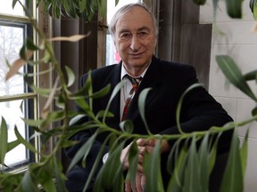 Ernest Small, principal research scientist at the Ottawa Research and Development Centre with the Government of Canada, poses for a photograph beside an oleander plant at his office in Ottawa, Thursday, January 4, 2018.