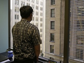 FILE - In this Sept. 22, 2016, file photo, Sorihin, who uses one name, one of two Indonesian fisherman who escaped slavery aboard a U.S.-flagged tuna and swordfish vessel when it docked at San Francisco's Fisherman's Wharf, looks out toward Montgomery Street at the offices of the Legal Aid Society in San Francisco. Attorneys for Sorihin and Abdul Fatah told The Associated Press on Wednesday, Jan. 3, 2018, that they settled their lawsuit against Thoai Van Nguyen, the California-based owner and captain of the Sea Queen II.