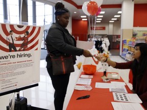 In this Sunday, Oct. 15, 2017, photo, Target human resources representative Brenda, right, talks with a job seeker at a Target store in Chicago. On Tuesday, Jan. 9, 2018, the Labor Department reports on job openings and labor turnover for November.