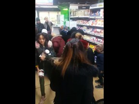 In this image taken from video a customer carries away pots of Nutella the chocolate and hazelnut spread, as others congregate around display of the product  in a supermarket in Toulon southern France on Thursday Jan. 25, 2018. Brawls broke out in French supermarkets on Thursday as shoppers scrambled to get their hands on discounted pots of the chocolate and hazelnut spread Nutella. (AP Photo)