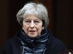 FILE - In this Wednesday, Jan. 10, 2018 file photo, Britain's Prime Minister Theresa May leaves 10 Downing Street to attend the weekly Prime Ministers' Questions session, in parliament in London. Theresa May is flying to China Tuesday Jan. 30, 2018, for a three-day trip seeking a major economic partner for post-Brexit Britain.