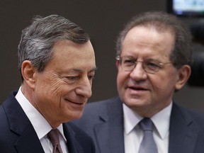 FILE- In this Thursday, Dec. 14, 2017 file photo, President of the European Central Bank Mario Draghi , left, and vice president Vitor Constancio go to a news conference in Frankfurt, Germany. Top officials at the European Central Bank at their last meeting Thursday, Jan. 11, 2018, were wary of prematurely signaling the next steps in an expected exit from their monetary stimulus polices.