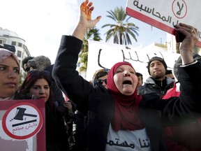 Family members of Tunisian who died in the revolution seven years ago, stage a protest in Tunis, Tunisia, Saturday, Jan. 13, 2018. European governments warned their citizens about potential rioting this weekend, when Tunisia marks seven years since the ouster of longtime strongman President Zine Ben Abidine Ben Ali.