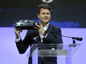 UPDATES TITLE TO SENIOR VICE PRESIDENT AMERICAS - Anders Gustafsson, senior vice president Americas Volvo Car Group, shows off the award for the North American Utility Vehicle of the Year, which was given to the 2018 Volvo XC60, at the North American International Auto Show, Monday, Jan. 15, 2018, in Detroit.
